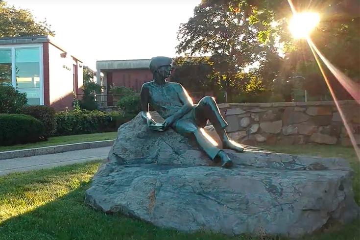 A statue in front of the Brandeis Libraries